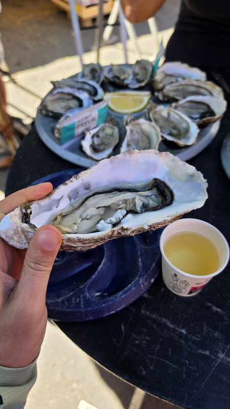 One oyster, one paper cup of white, market breakfast